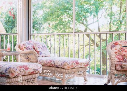 Wicker furniture featured in an enclosed porch in a Florida home, USA Stock Photo