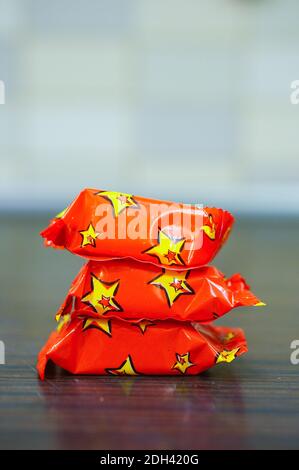 The stack of candy wrapped in red paper Stock Photo