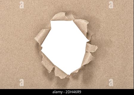 White hole in craft torn paper background. Recycled carton texture Stock Photo