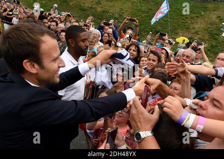 French President Emmanuel Macron (L) shakes hands with people as he arrives in Saint-Martin d'Arc, on July 19, 2017 to meet former cyclists and follow the 183 km seventeenth stage of the 104th edition of the Tour de France cycling race between Le La Mure and Serre-Chevalier, French Alps. Photo by Jean-Pierre Clatot/Pool/ABACAPRESS.COM Stock Photo