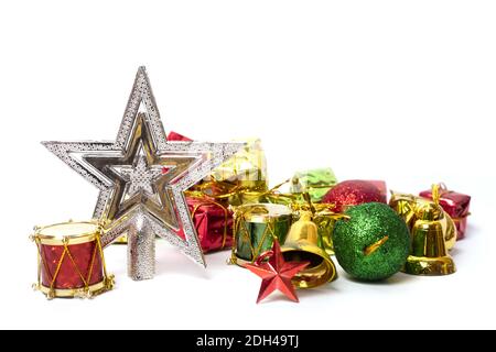 The holiday ornaments of a Christmas tree: silver star, glittery balls, gift boxes, bells, and drums Stock Photo