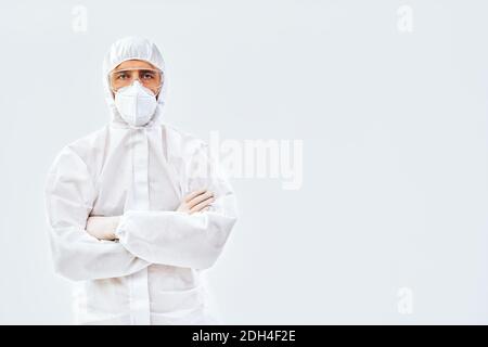 Confident doctor with crossed arms in protective medical suit Stock Photo