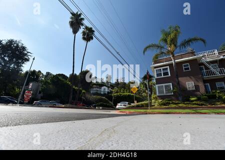 The city of Los Angeles is testing a unique grey substance designed to keep roads cooler by 11F-13F. The $150,000 pilot project in 15 council district aims to keep surrounding homes cooler as a result. A CoolSeal coating could cost an estimated $40,000 per mile and last seven years. Average temperatures in Los Angeles have risen 5 degrees in the past 100 years on account of the heat island effect produced by miles of asphalt freeways, roads, parking lots, roofs and more, climatologists say. In summer, temperatures have risen an average 10 degrees. Los Angeles, CA, USA, August 14, 2017. Photo b Stock Photo