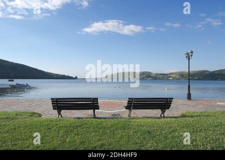 two benches with a view of a lake in the luminous landscape Stock Photo