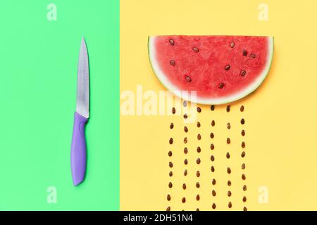 Watermelon slice with seeds and knife Stock Photo