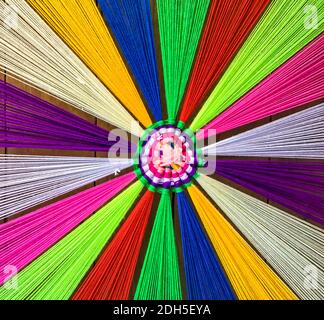Various colored threads on wooden floor for decoration. Stock Photo