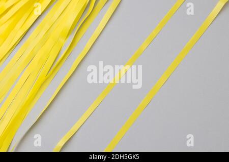 Abstract gray background with bright yellow wavy paper stripes. Stock Photo