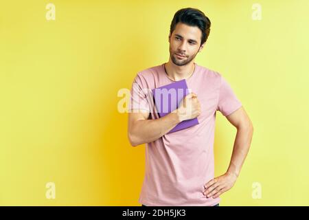 Portrait of young handsome man with book Stock Photo