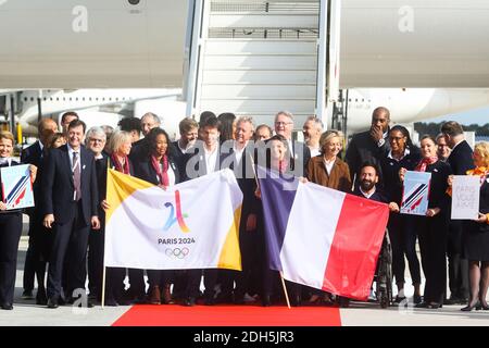 Paris Mayor Anne Hidalgo (C) poses with Paris 2024 Bid Co-Chair Tony Estanguet (5L) Ile-de-France regional president Valerie Pecresse (8R), Paris 2024 Bid Co-Chair Bernard Lapasset (C/R) French former Olympic champion, former politician and International Olympic Committee (IOC) member Guy Drut (C/L) French wheelchair tennis player Michael Jeremiasz (C/R) and President of The French Paralympic Committee Emmanuelle Assmann (C/L) and French Sport Minister Laura Flessel (4L), Teddy Riner after disembarking from an aircraft at Roissy-Charles de Gaulle Airport on the outskirts of Paris on September Stock Photo