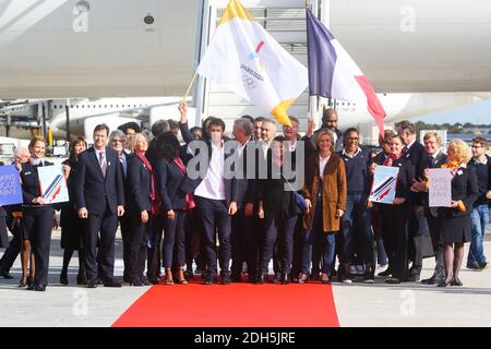 Paris Mayor Anne Hidalgo (C) poses with Paris 2024 Bid Co-Chair Tony Estanguet (5L) Ile-de-France regional president Valerie Pecresse (8R), Paris 2024 Bid Co-Chair Bernard Lapasset (C/R) French former Olympic champion, former politician and International Olympic Committee (IOC) member Guy Drut (C/L) French wheelchair tennis player Michael Jeremiasz (C/R) and President of The French Paralympic Committee Emmanuelle Assmann (C/L) and French Sport Minister Laura Flessel (4L), Teddy Riner after disembarking from an aircraft at Roissy-Charles de Gaulle Airport on the outskirts of Paris on September Stock Photo