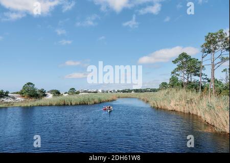 Kayakers on Western Lake, a coastal dune lake in Grayton Beach State Park, in the Florida panhandle county of South Walton, USA. Stock Photo