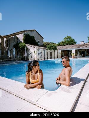 Couple relaxing by the pool in the Provence France, men and woman relaxing by pool at luxury resort