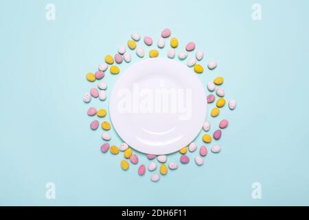 Easter blue background with eggs, plate. White plate for Easter treat. Mock up. Option of serving for children's Easter holiday.  Stock Photo