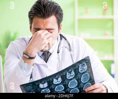 Doctor radiologist looking at x-ray scan in hospital Stock Photo