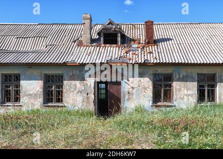 Old destroyed abandoned raw wooden house with the broken out windows Stock Photo