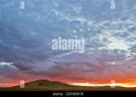 Evening cloudy sky over the sand dunes. Stock Photo