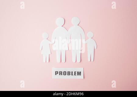 paper family cut out on bright pink background, family home Stock Photo