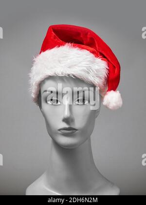 Front view of Santa Claus hat stock image on grey background for Christmas occasion stock images Stock Photo