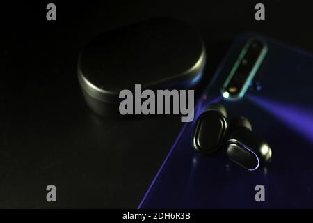 wireless earphones and a cell phone Stock Photo