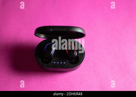 wireless earphones and a cell phone Stock Photo