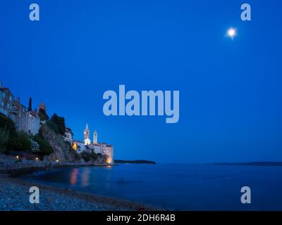 Blue hour and full moon on a beach at island rab in croatia Stock Photo