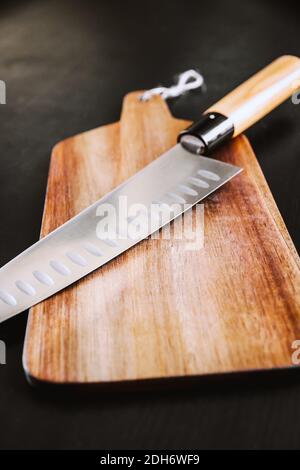 Traditional Japanese gyuto knife on a cutting board Stock Photo