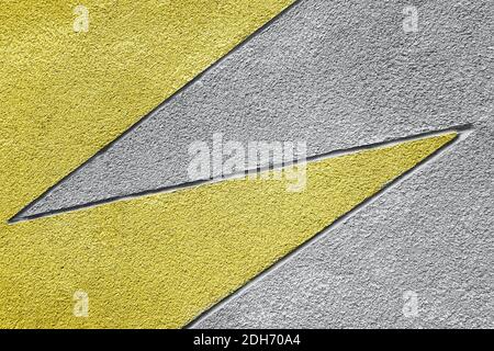 Yellow and gray stone wall with geometric pattern, background, texture. Trendy colors 2021. Stock Photo