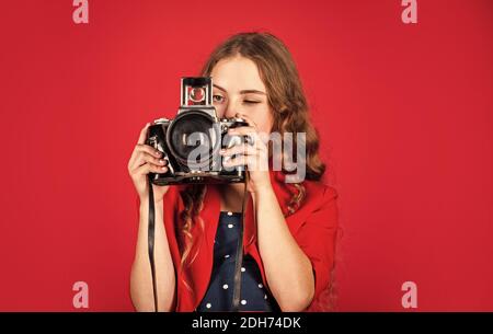 Girl with retro camera. Capture moments. SLR camera. Courses for photographers. Education for reporters and journalists. Learn use presets. Editing photos. Manual settings. Professional camera. Stock Photo