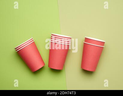 Stack of red paper disposable cups on a blue background, flat lay, concept eco-friendly Stock Photo