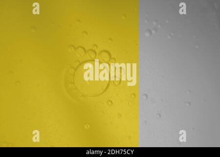 Macro fluid with bubbles, abstract yellow and gray background. Selective focus. Stock Photo