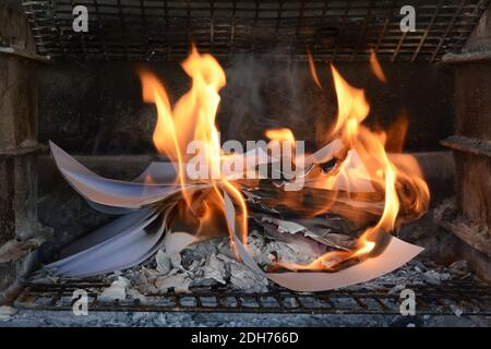 Burning paper documents. Flames and scorched paper. Good example of destroying evidence by burning it. Ashes left behind. Stock Photo