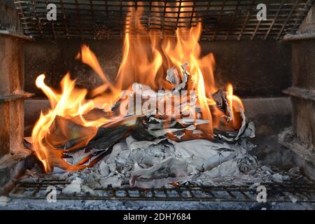 Burning paper documents. Flames and scorched paper. Good example of destroying evidence by burning it. Ashes left behind. Stock Photo