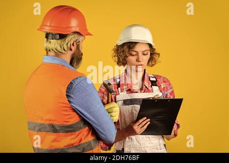 work at construction site or factory. Civil engineering. industrial business partner. job and occupation. confident electrical and technician. engineers couple working together on building blueprint. Stock Photo