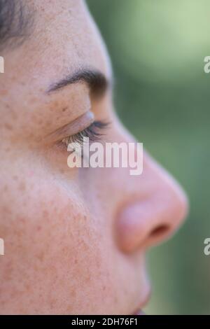 Close up of woman's eye looking away outdoors Stock Photo