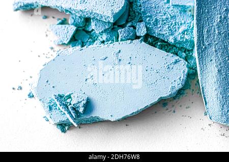 Blue eye shadow powder as makeup palette closeup isolated on white background, crushed cosmetics and beauty texture Stock Photo