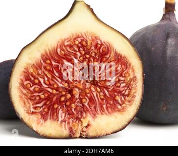 Ripe whole and halved purple figs isolated on white background Stock Photo