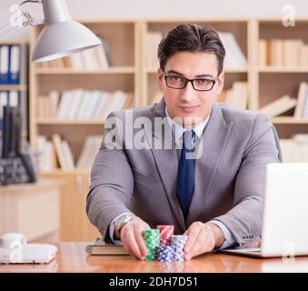 Businessman gambling playing cards at work Stock Photo