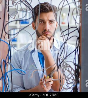 Computer repairman working on repairing network in IT workshop Stock Photo
