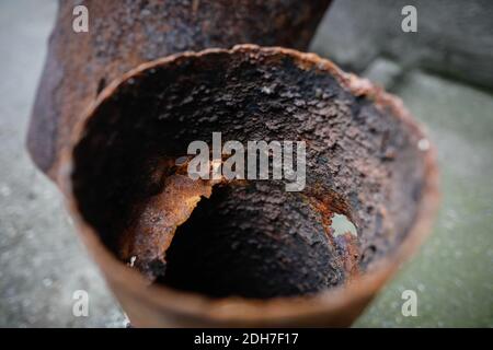 Shallow depth of field (selective focus) image with a very rusty metal pipe. Stock Photo