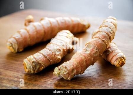 Turmeric root on a cutting board Stock Photo