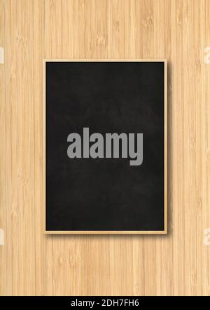 Traditional black board isolated on a wooden background Stock Photo