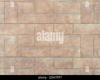 Beige wall with embossed rectangular tiles lined with pattern. Background texture Stock Photo