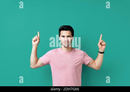 Handsome happy man pointing his finger showing empty copy space Stock Photo