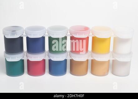 Plastic jars with multicolored gouache paints. Stock Photo