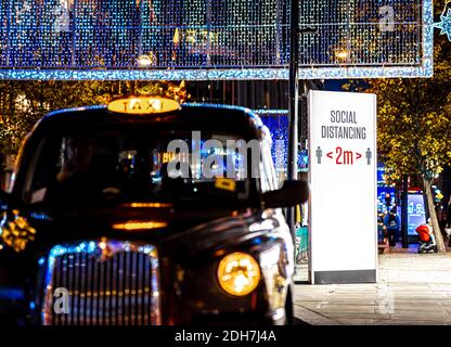 A social distancing stand on Oxford Street, a major road in the City of Westminster in the West End of London, UK Stock Photo