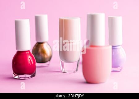 Nail polish bottles on pink background, beauty brand Stock Photo