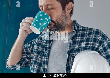 Construction engineer on a morning coffee break, relaxing and preparing for work Stock Photo