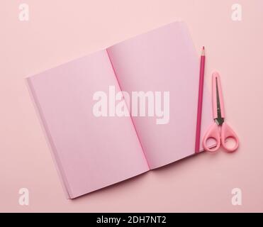 Open notebook with blank pink pages on a pink background Stock Photo