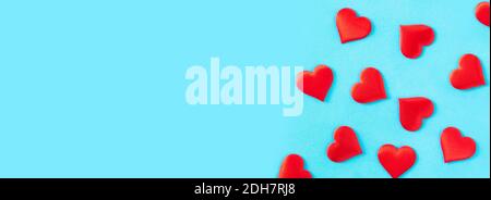 Red hearts on blue background. Stock Photo