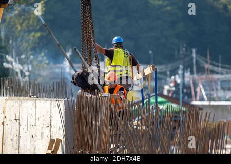 Unrecognizable builders working in port Stock Photo